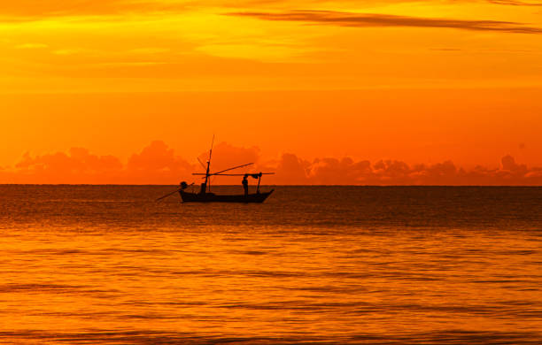 Long tail boat in the sunrise over sea