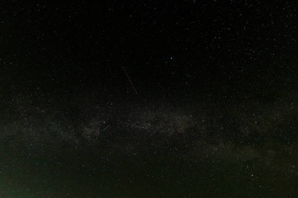 Clear night sky filled with stars and a hint of the Milky Way.