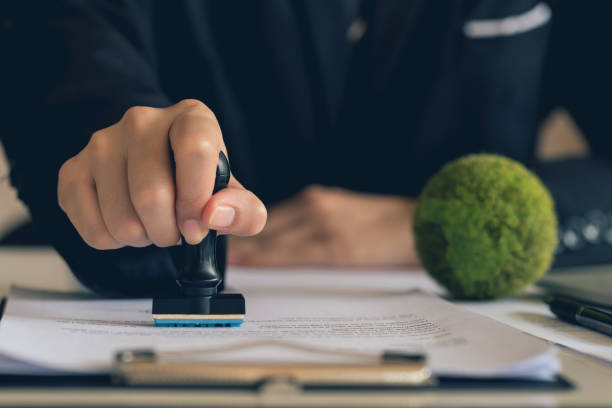 istock Business Hand Stamp With Approved Stamp On Document. validates and manages business documents agreements and approves Green business companies with eco-friendly waste management regulation concept.ESG 2161958721