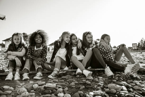 Six girlfriends spend the weekend sitting on a rocky beach