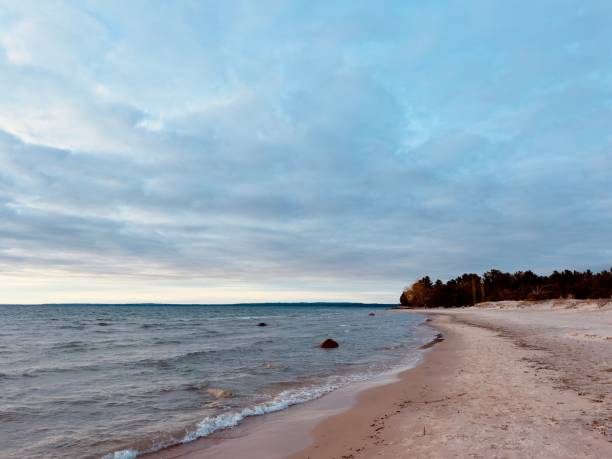 istock a seaside promenade with calm waves and a cloudy evening sky 2161961201