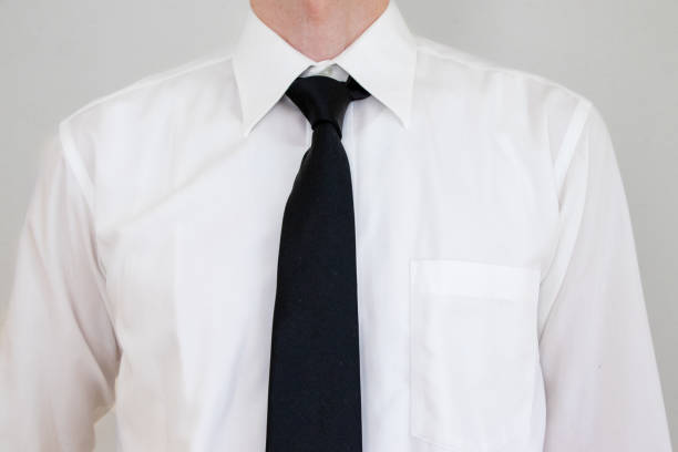 A man in a white shirt wearing a black tie