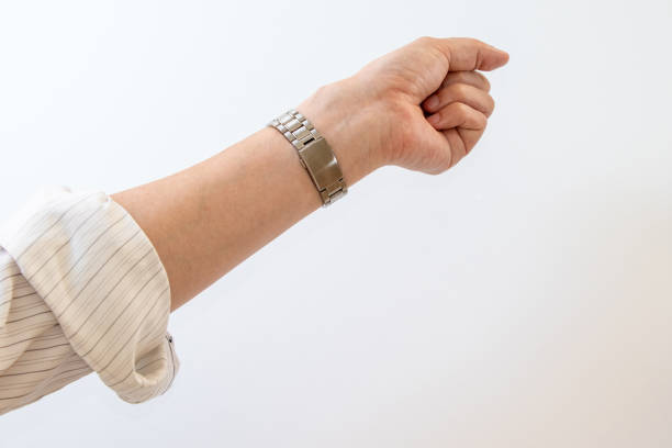 A man's arm with his shirt sleeves rolled up