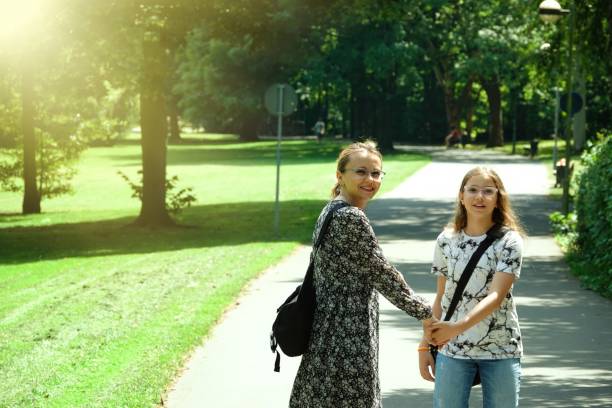 istock Mother and Daughter are Walking in Park 2161962890