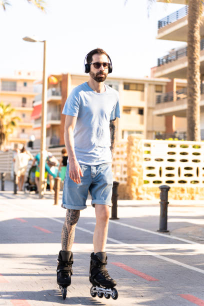 istock Young European hipster guy skating on the beach 2161964478