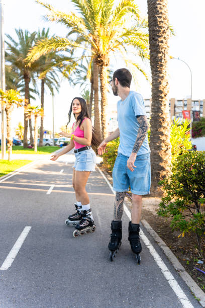 istock Multiethnic couple roller skating on the beach 2161964540