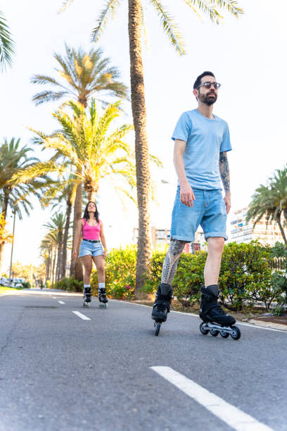 istock Multiethnic couple roller skating on the beach 2161964546