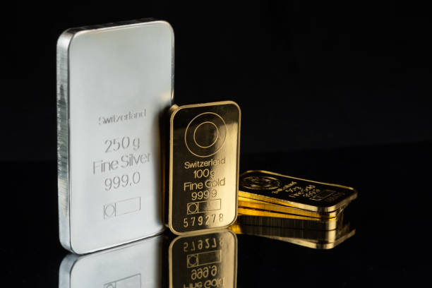 istock Gold and silver bars of various weights on a black mirror background. 2161968978