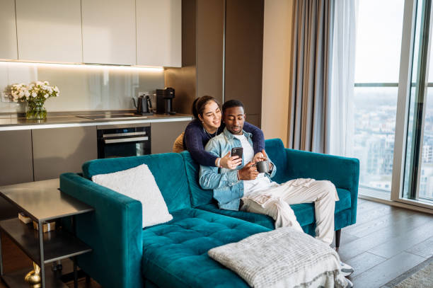 istock Diverse millennial couple in modern apartment taking selfie 2161969722