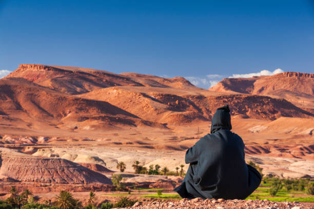 istock Maroccan man looking at High Atlas mountain range 2161971315