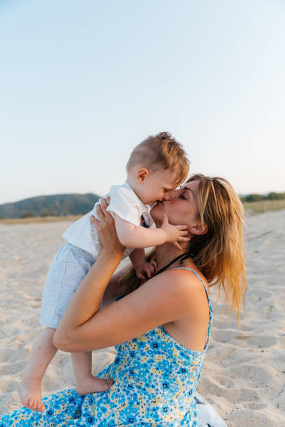 istock Mother playing with her baby on the beach 2161971811