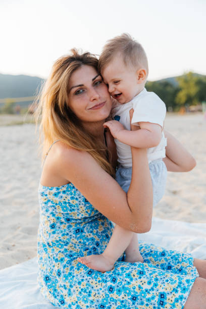 istock Mother playing with her baby on the beach 2161971886