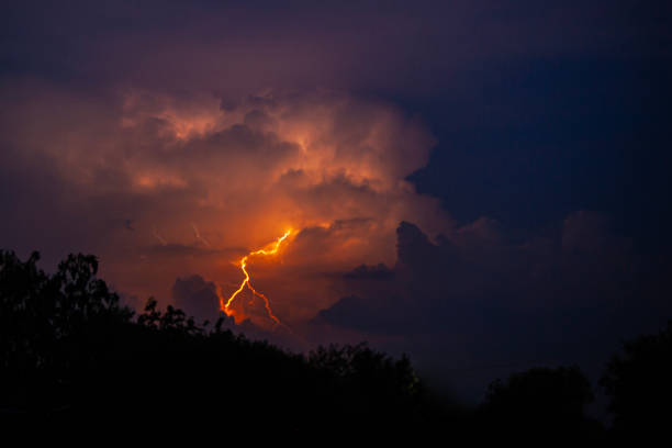 istock beautiful lightning during a thunderstorm at night in a forest that caused a fire, against a dark sky with rain 2161972492