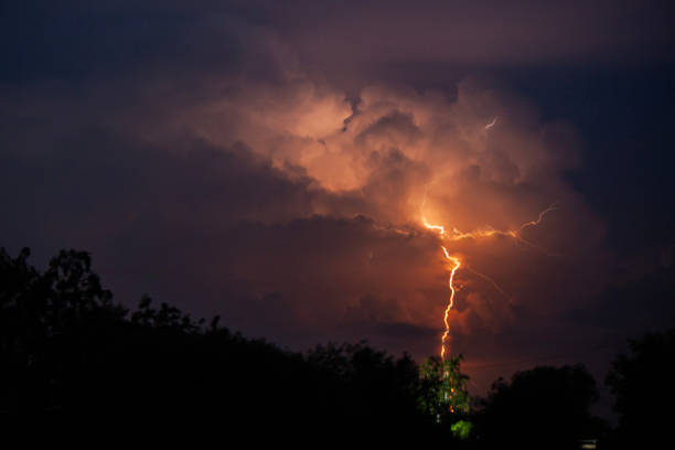 istock beautiful lightning during a thunderstorm at night in a forest that caused a fire, against a dark sky with rain 2161972495