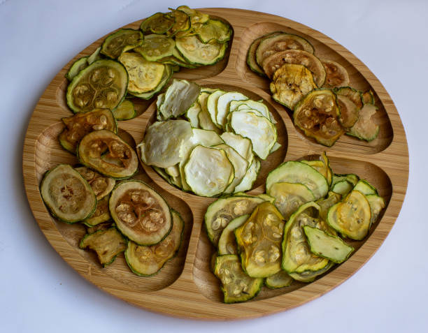 istock Dried zucchini slices on a wooden plate 2161973363
