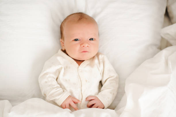 istock Baby boy lying in bed sleeping 2161973646