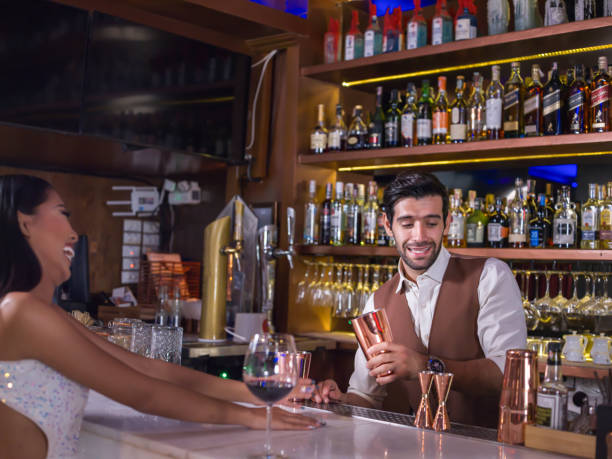istock Bartender is making cocktail with talking customer at bar counter 2161974029