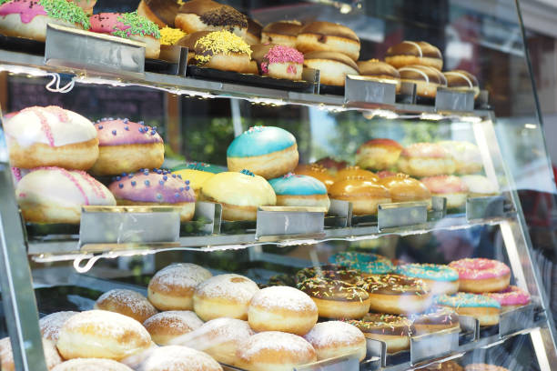 istock chocolate donuts display for sale at local store 2161975238
