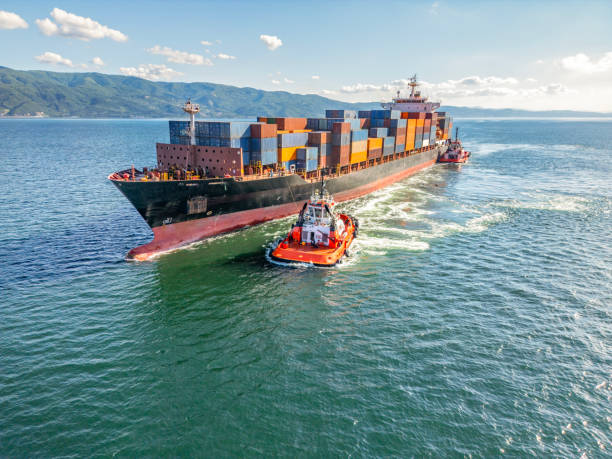 Tug boat taking out the ship from the harbor