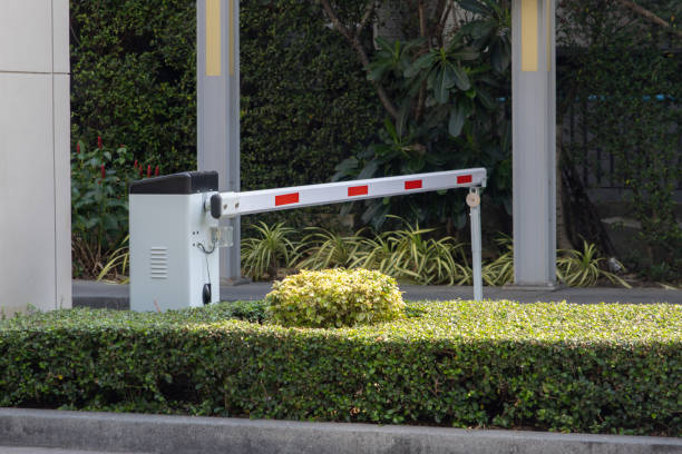 istock A red and white traffic barrier is in front of a bush 2161975947