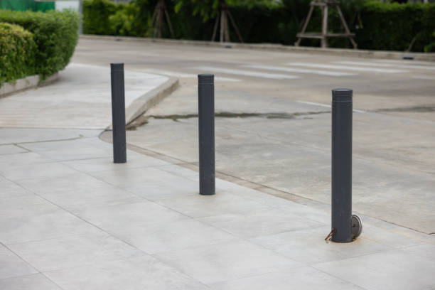 istock Three black poles are lined up on a sidewalk 2161976017