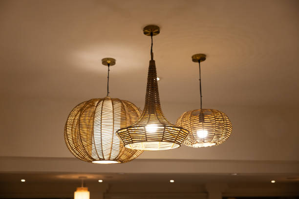 istock Three lamps hanging from the ceiling, one of which is a large round lamp 2161976113