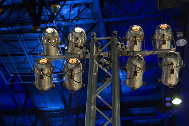 A large light fixture with many lights on it. The lights are all lit up and the fixture is hanging from the ceiling