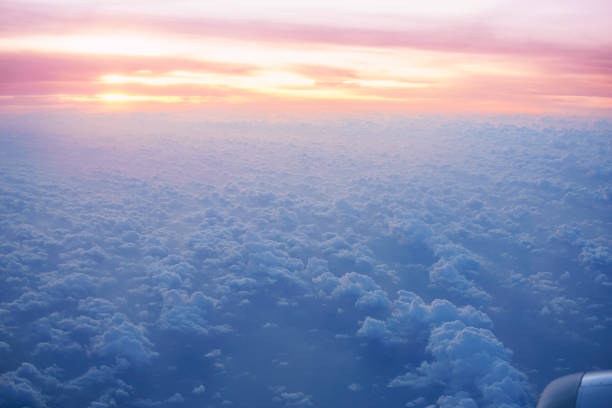 View of clouds from plane at sunrise