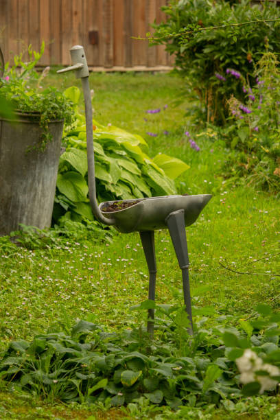 istock Garden decor. Figurine with flower on the grass. 2161982876