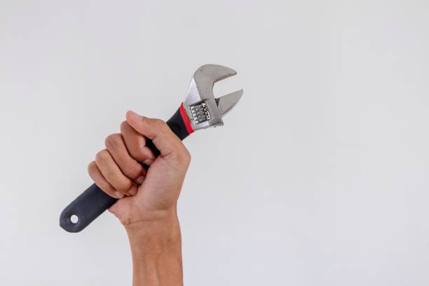 istock Hand holding an adjustable wrench or adjustable spanner isolated on white background 2161986934