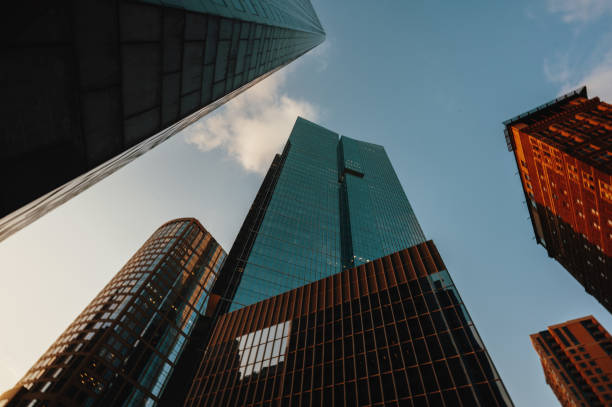 istock Low angle view of modern office buildings in golden hour 2161988324