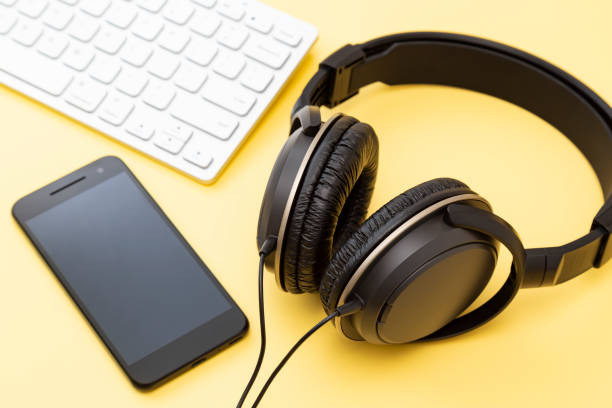 istock Headphones, computer and smartphone on a yellow background 2161990979