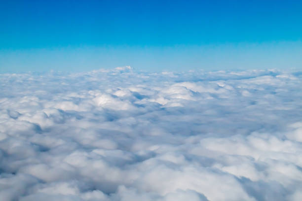 Cloudy landscape at 12,000 meters above sea level. Flying above the clouds.