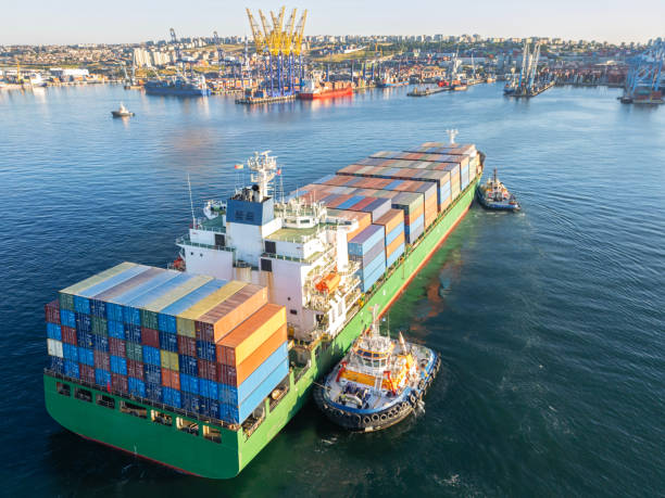 istock Aerial view of Cargo Container Ship approaching port with tugboat. 2161995879