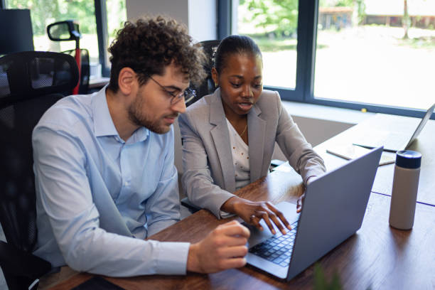 istock Collaboration in the modern office: Business team on laptops 2161996055