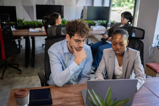 istock Collaboration in the modern office: Business team on laptops 2161996063