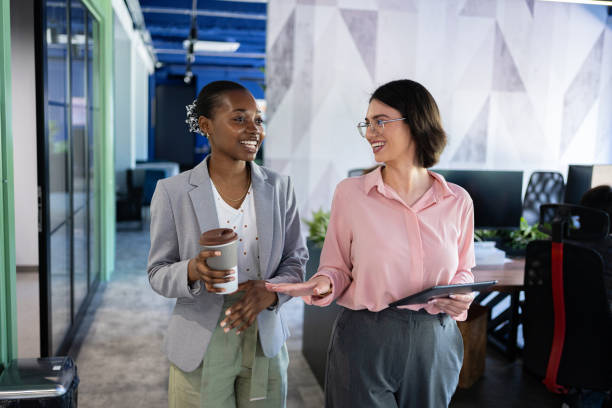 istock Relaxed business conversation: Young female leaders over coffee in a modern office 2161996079