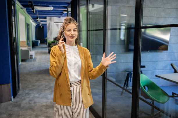 istock A young manager is talking on the phone in an open office space 2161996136