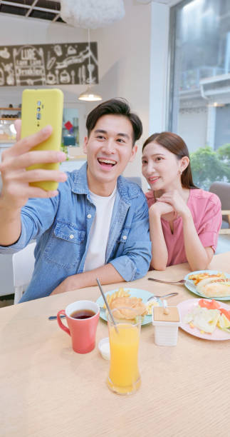 istock couple take selfie by mobile 2161998100