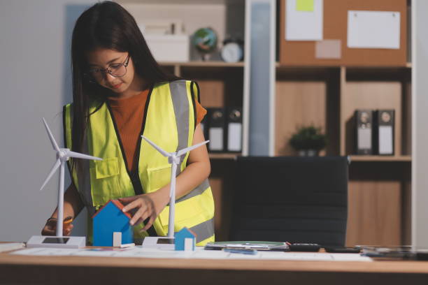 istock Female architect working at home She looked at the blueprint. 2161998362