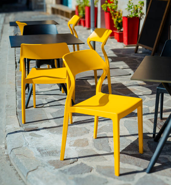 istock Outdoor Cafe Seating With Modern Yellow and Black Chairs 2162003622