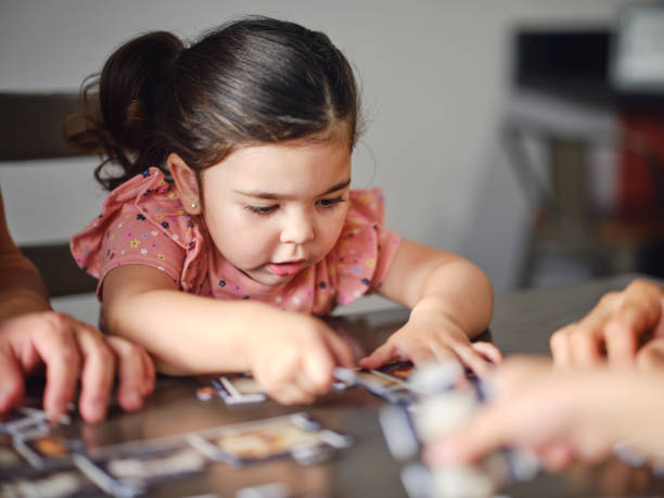 istock Family at Home Doing a Puzzle Together 2162004243