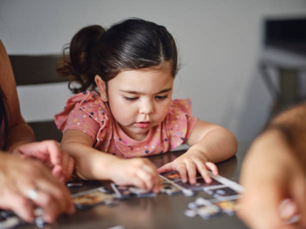 istock Family at Home Doing a Puzzle Together 2162004250