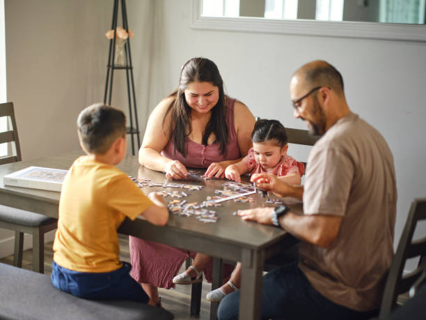 istock Family at Home Doing a Puzzle Together 2162004258