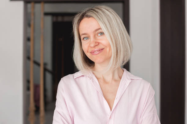 istock Smiling middle aged mature woman looking at camera at home 2162006365