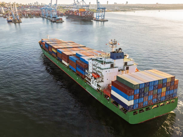 istock Aerial view of Cargo Container Ship approaching port with tugboat. 2162008177