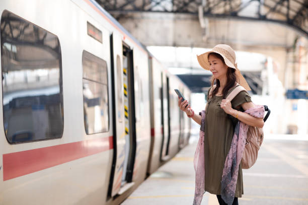istock Mature Asian woman checking train schedule on phone 2162010669