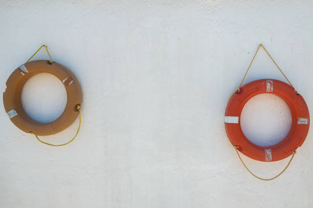 Lifeguard equipment, orange lifebelt with rope hang on the wall