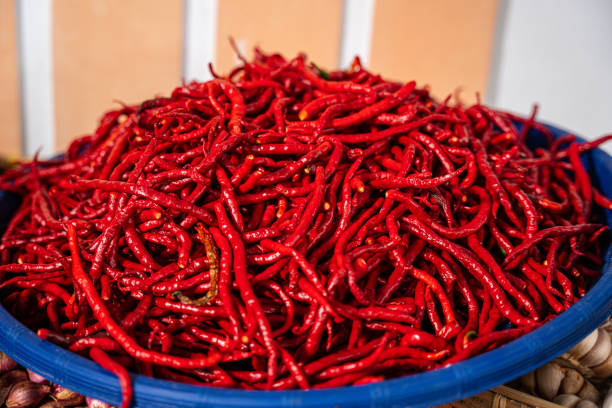 pile of Fresh Chilies and Ripe Red Chilies in Baskets for Sale at the Vegetable Market