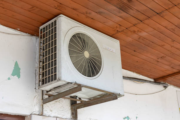 istock air conditioner hanging behind the wall under the roof 2162012880